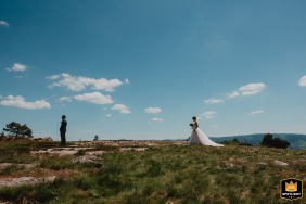 Bride's arrival behind the groom on a mountaintop in the Swiss Alps, moments before he turns.